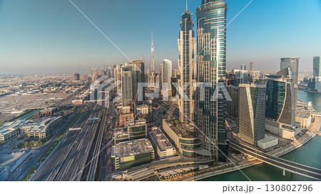 Sunset skyline with modern skyscrapers and traffic on sheikh zayed road timelapse in Dubai, UAE. 130802796