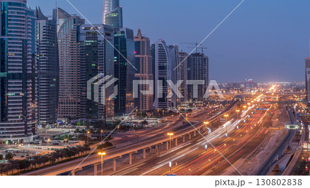 Aerial top view to Sheikh Zayed road near Dubai Marina and JLT night to day timelapse, Dubai. Aerial top view to Sheikh Zayed road near Dubai Marina and JLT night to day timelapse, Dubai. 130802838