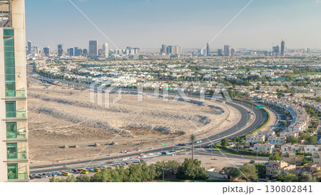 Aerial view to villas and houses with Golf course with green lawn and lakes timelapse 130802841