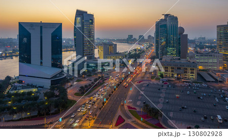 Dubai creek landscape day to night timelapse with boats and ship near waterfront 130802928