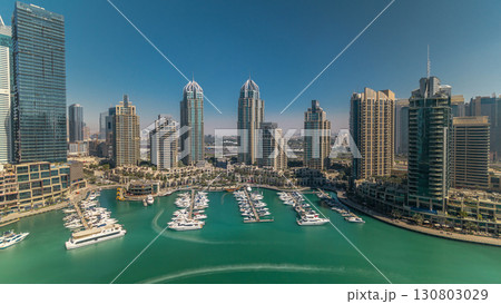 Dubai Marina skyscrapers aerial all day timelapse, port with luxury yachts and marina promenade 130803029