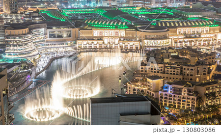 Night aerial view Dancing fountains downtown and in a man-made lake timelapse in Dubai, UAE. 130803086