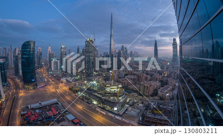 Dubai Downtown night to day timelapse. Aerial view over big futuristic city by night. Dubai Downtown night to day timelapse. Aerial view over big futuristic city by night. 130803211