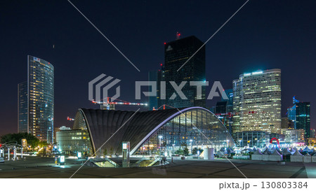 Panorama of illuminated skyscrapers timelapse in famous financial and business district of Paris - La Defense. Panorama of illuminated skyscrapers timelapse in famous financial and business district of Paris - La Defense. 130803384