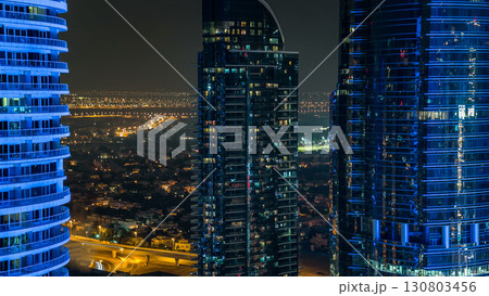 Buildings of Jumeirah Lakes Towers with traffic on the road aerial night timelapse. 130803456