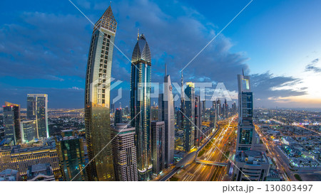 Dubai downtown architecture day to night timelapse. Top view over Sheikh Zayed road with illuminated skyscrapers and traffic. Dubai downtown architecture day to night timelapse. Top view over Sheikh Zayed road with illuminated skyscrapers and traffic. 130803497