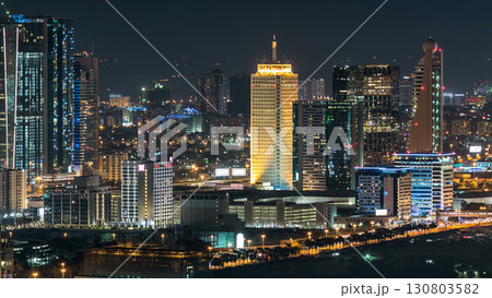 Dubai downtown skyline timelapse at night. Rooftop view of Sheikh Zayed road with numerous illuminated towers. 130803582