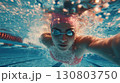 Focused swimmer gliding underwater with power, bubbles and light enhancing motion 130803750
