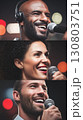 Smiling performers with microphones sharing joy and energy on stage together 130803751