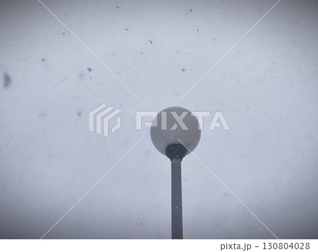 lamppost during snowfall in winter. winter snowstorm on the background of a lamppost in daytime. Blizzard in winter. 130804028