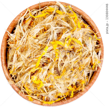 Mountain arnica in a small wooden bow isolated on white. 130804446