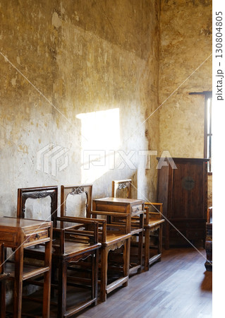 Close up old wooden cabinet and chair furniture of Chinese style in vintage and rustic grunge concrete wall in literature room with natural sunlight in Bangkok of Thailand. Vertical Photo 130804805