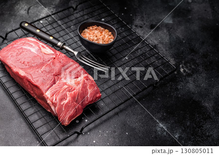 Close-up of raw horse meat, emphasizing its quality and freshness, ready to be transformed into exquisite dishes for adventurous palates. black background. top view 130805011