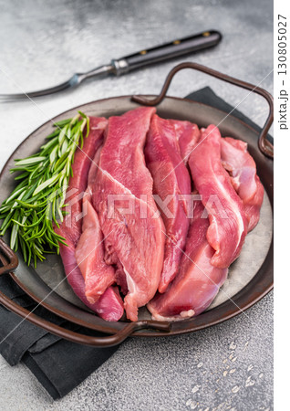 Slices of duck breast fillet, raw fresh poultry meat. grey background. top view Slices of duck breast fillet, raw fresh poultry meat. grey background. top view 130805027