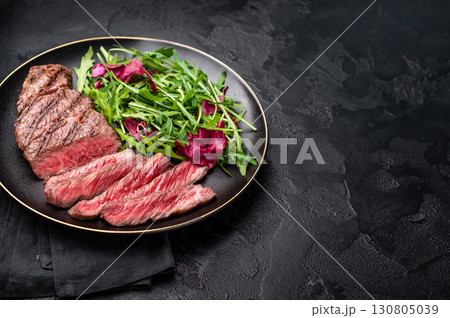 Succulent Denver cut, showcasing a perfect sear and rich color after grilling. black background. top view Succulent Denver cut, showcasing a perfect sear and rich color after grilling. black background. top view 130805039