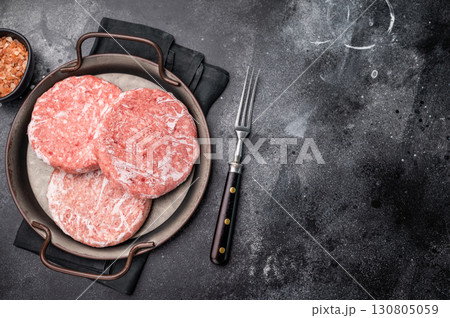 Frozen Meat cutlet, mincemeat of pork and beef for burgers. black background. top view 130805059