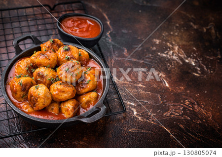 Juicy meatballs, perfectly seasoned and beautifully browned, ready to be served with marinara sauce. A classic comfort food that never disappoints. brown background. top view Juicy meatballs, perfectly seasoned and beautifully browned, ready to be served with marinara sauce. A classic comfort food that never disappoints. brown background. top view 130805074
