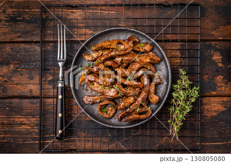 Traditional Asian beef teriyaki with herbs on a plate. wooden background. top view Traditional Asian beef teriyaki with herbs on a plate. wooden background. top view 130805080