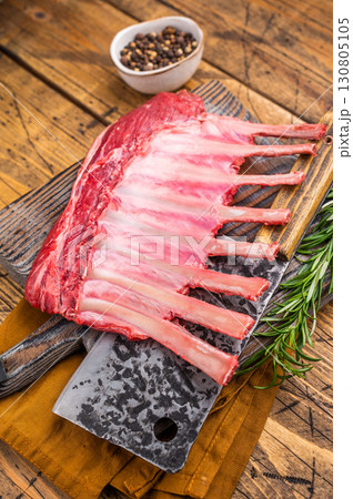 Butcher board with Raw lamb meat for chops steaks, fresh rack of mutton. wooden background. top view Butcher board with Raw lamb meat for chops steaks, fresh rack of mutton. wooden background. top view 130805105