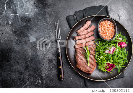 Grilled Top blade steak with salad, beef shoulder meat on a plate. black background. top view Grilled Top blade steak with salad, beef shoulder meat on a plate. black background. top view 130805112