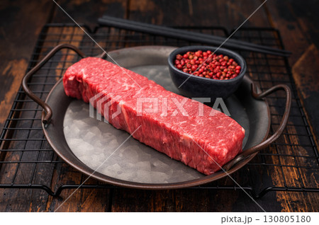 High quality marbled wagyu beef steak, ready to be transformed into a gourmet masterpiece. A delicious choice for any meat lover's palate. wooden background. top view 130805180