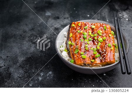 Unagi don, Unagidon Japanese grilled eel with rice in a bowl. black background. top view 130805224