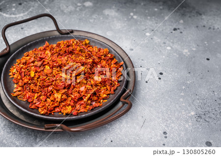 Dried Tomato Flakes, Indian and Arabic spices for cooking. grey background. top view 130805260
