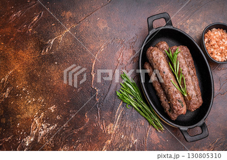BBQ roast Turkish Urfa kebab with herbs. brown background. top view 130805310