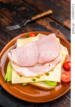 Prosciutto Cotto Ham and cheese sandwich, toast with sliced meat, cheese and salad. wooden background. top view Prosciutto Cotto Ham and cheese sandwich, toast with sliced meat, cheese and salad. wooden background. top view 130805413