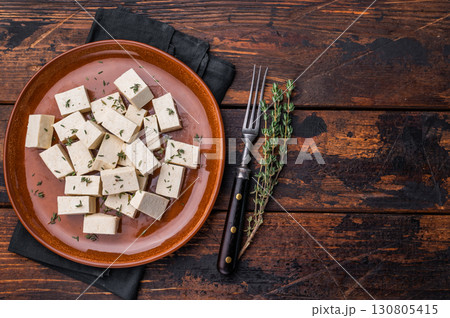 Uncooked Diced soybean tofu cheese on plate. wooden background. top view 130805415