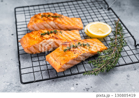 Grilled salmon fillet steak, roast fish on a rack. grey background. top view 130805419