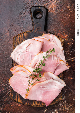 Ham Prosciutto Cotto, Sliced Pork Ham on wooden board. brown background. top view Ham Prosciutto Cotto, Sliced Pork Ham on wooden board. brown background. top view 130805427