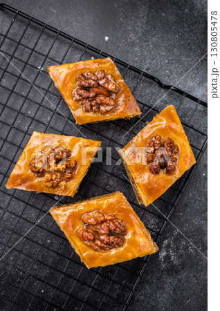 Traditional Honey Walnut Baklava. black background. top view Traditional Honey Walnut Baklava. black background. top view 130805478
