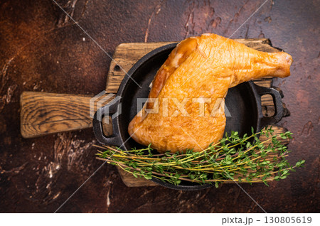 BBQ Smoked chicken leg, poultry meat in skillet. brown background. top view BBQ Smoked chicken leg, poultry meat in skillet. brown background. top view 130805619