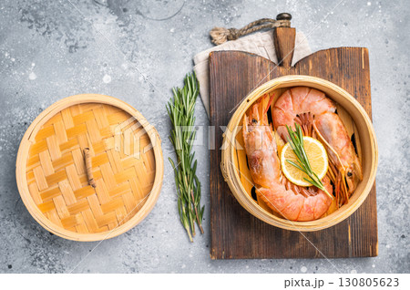 Steamed Red shrimps, Prawns in bamboo steamer. grey background. top view Steamed Red shrimps, Prawns in bamboo steamer. grey background. top view 130805623