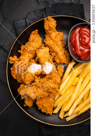 Deep fried chicken strips, sticks with french fry and sauce. black background. top view 130805637