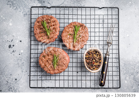 BBQ Grilled burger beef meat cutlets, chooped roast meat. grey background. top view 130805639