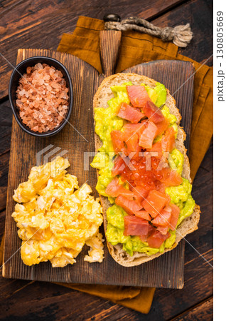Sandwich with smoked salmon, trout, avocado and red caviar. wooden background. top view Sandwich with smoked salmon, trout, avocado and red caviar. wooden background. top view 130805669