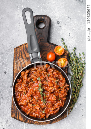 Italian bolognese sauce with ground beef in a pan. grey background. top view 130805673