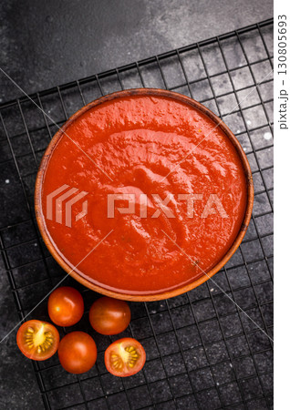 Canned Tomato sauce Passata, preserved paste for cookng. black background. top view Canned Tomato sauce Passata, preserved paste for cookng. black background. top view 130805693