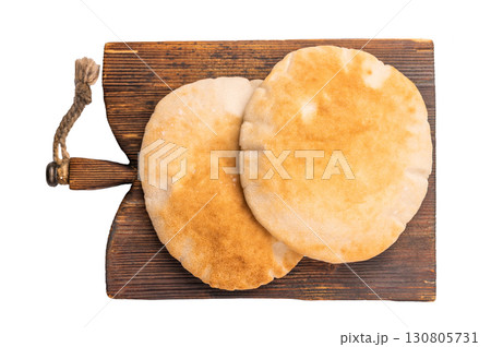 A stack of pita breads isolated on white background. top view A stack of pita breads isolated on white background. top view 130805731