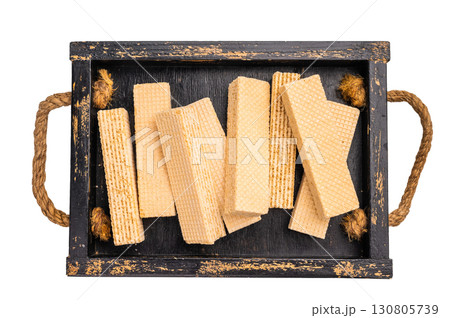 Wafer stick biscuits with vanilla cream in wooden tray isolated on white background. top view 130805739