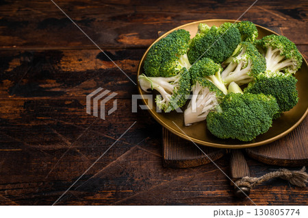 Fresh broccoli cabbage pieces on a plate. wooden background. top view 130805774
