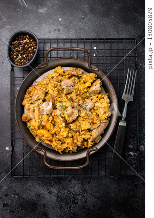 Arabic national rice food pilaf or plov, cooked with fried lamb and beef meat. black background. top view 130805829