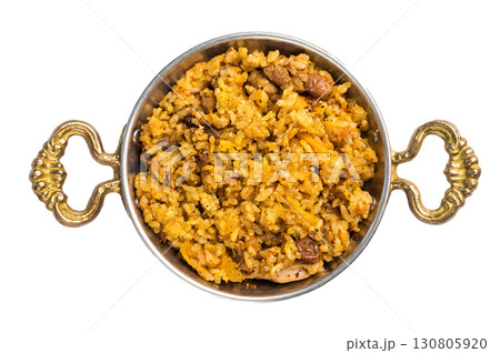 Pilaf with beef and lamb meat, vegetables in a skillet isolated on white background 130805920