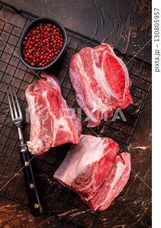 Thick Cut raw Beef Short Ribs, fresh meat with bone. brown background. top view 130805957