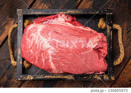 Unccoked Top Round beef, raw topround roast meat with thyme. wooden background. Top view Unccoked Top Round beef, raw topround roast meat with thyme. wooden background. Top view 130805973
