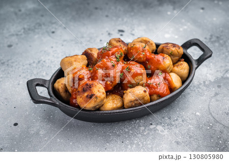 Roast meatballs served with tomato sauce. A classic comfort food in a skillet. grey background. top view Roast meatballs served with tomato sauce. A classic comfort food in a skillet. grey background. top view 130805980
