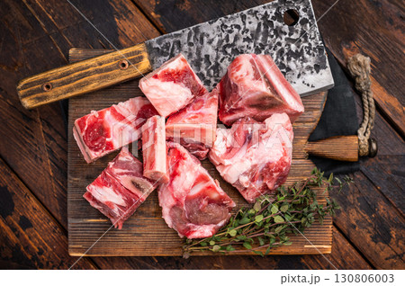 Raw diced Beef meat with bones for stew or goulash on wooden board. wooden background. top view Raw diced Beef meat with bones for stew or goulash on wooden board. wooden background. top view 130806003