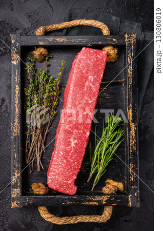 Fresh wagyu brisket cut, beautifully presented with intricate marbling. A must-have for steak enthusiasts looking to elevate their dining options. black background. top view Fresh wagyu brisket cut, beautifully presented with intricate marbling. A must-have for steak enthusiasts looking to elevate their dining options. black background. top view 130806019